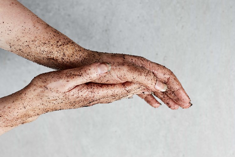 hands covered with coffee grounds