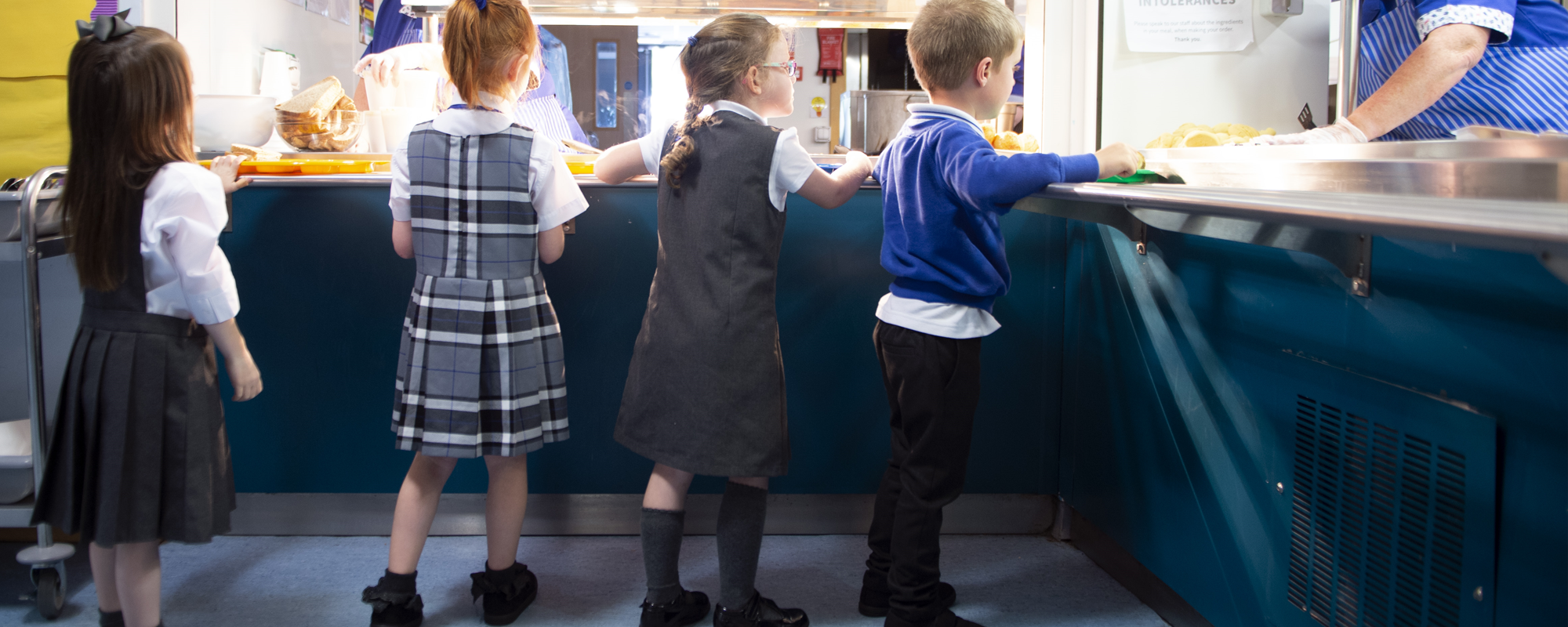 full primary pupils collect their school lunch.png