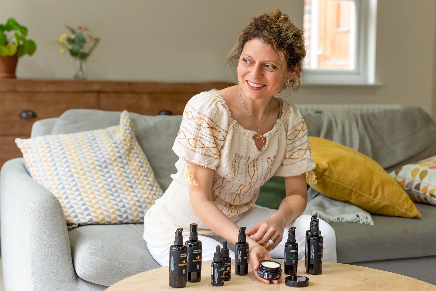 woman in front of her skincare range